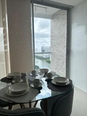 a dining room table with a view of a river at Hermoso apto, cerca al mar in Cartagena de Indias
