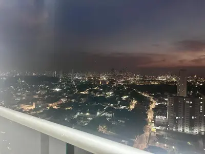 a view of a city at night from a window at Hermoso apto, cerca al mar in Cartagena de Indias