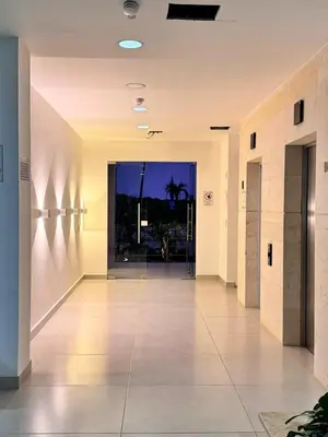 an empty hallway in a building with a large glass door at Apartamento con piscina, playa y cerca aeropuerto de Cartagena in Cartagena de Indias