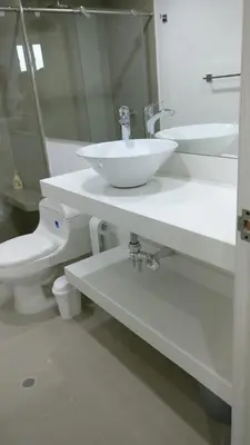 a white bathroom with a sink and a toilet at Vista Lateral al Mar, ApartaEstudio , Cerca Hotel Hilton y Salida al Mar in Cartagena de Indias