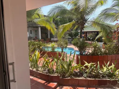 a view of a resort with a pool and palm trees at Club House in Maizal
