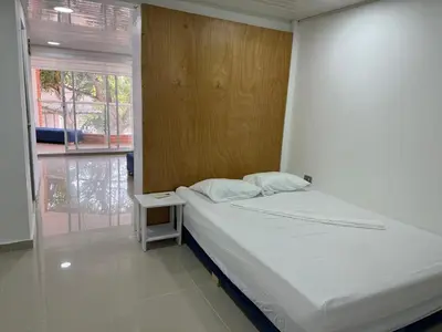 a bedroom with a bed and a table and a window at Club House in Maizal