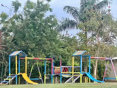 a playground with colorful equipment in a park at Hacienda Villa Hermelina-Casa Campestre in Turbaco