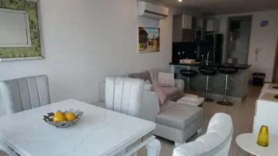 a living room with a couch and a table with a bowl of fruit at Palmetto Sunset in Cartagena de Indias