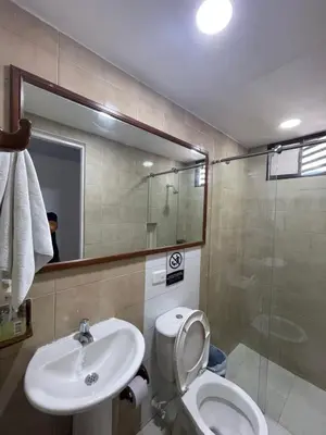 a bathroom with a toilet and a sink and a shower at Vista Hermosa Portofino in Cartagena de Indias
