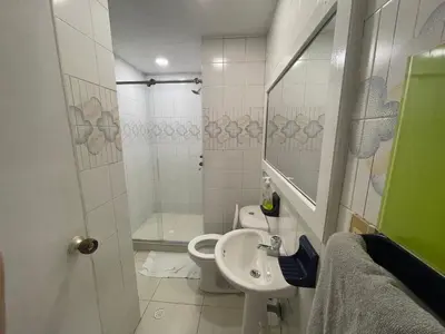 a bathroom with a toilet and a sink and a shower at Vista Hermosa Portofino in Cartagena de Indias