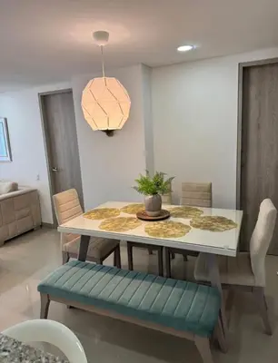 a dining room with a table and a pendant light at Hermoso apartamento moderno con vista al mar in Cartagena de Indias