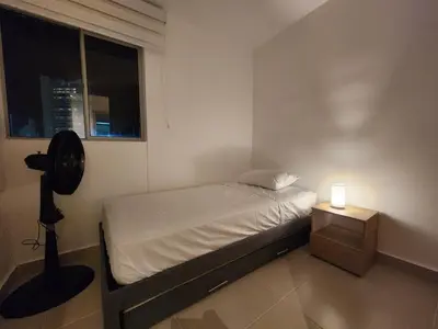 a small bedroom with a bed and a window at New and with an ocean view in Cartagena de Indias