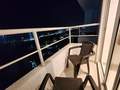 two chairs on a balcony with a view of the city at New and with an ocean view in Cartagena de Indias