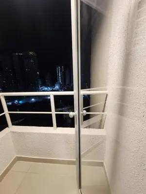 a balcony with a view of a city at night at New and with an ocean view in Cartagena de Indias