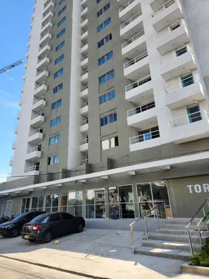 a large building with cars parked in front of it at New and with an ocean view in Cartagena de Indias