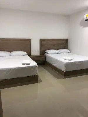 two beds in a room with at Hotel Brisas in Tierra Bomba