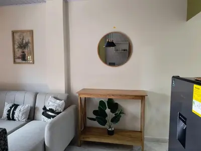 a living room with a couch and a mirror at Cactus Beach Stay APARTAMENTO in Santa Marta