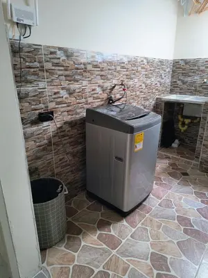 a bathroom with a trash can and a brick wall at Cactus Beach Stay APARTAMENTO in Santa Marta