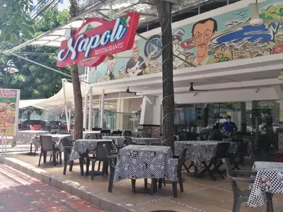 a restaurant with tables and chairs in front of it at PISO 12 Cerca a la playa, Piscina, Wifi, AC in Cartagena de Indias