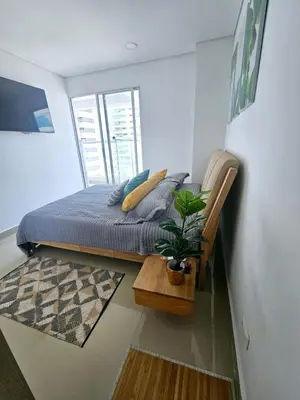 a bedroom with a bed and a potted plant at Bocagrande Urban loft in Cartagena de Indias