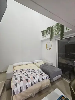 a bedroom with two beds and a window at Bocagrande Urban loft in Cartagena de Indias