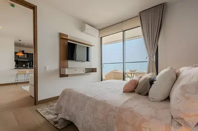 a bedroom with a large bed with a large window at Nuevo Vista al Mar / Centro Histórico Piso 28 in Cartagena de Indias