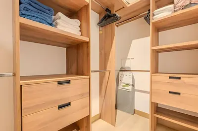 a walk in closet with wooden cabinets and a tv at Nuevo Vista al Mar / Centro Histórico Piso 28 in Cartagena de Indias