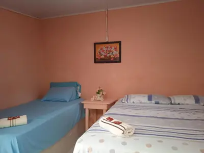two beds sitting next to each other in a room at Hotel Doña Edita in San Bernardo del Viento