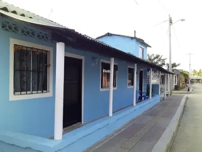 a blue building on the side of a street at Hotel Doña Edita in San Bernardo del Viento