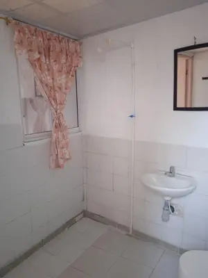 a white bathroom with a sink and a shower at Hotel Doña Edita in San Bernardo del Viento