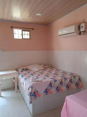a small bedroom with a bed and a window at Hotel Doña Edita in San Bernardo del Viento