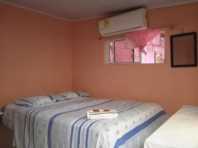 a bedroom with two beds and a window at Hotel Doña Edita in San Bernardo del Viento