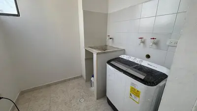 a small white kitchen with a stove and a counter at Apartamento central en Barranquilla in Barranquilla