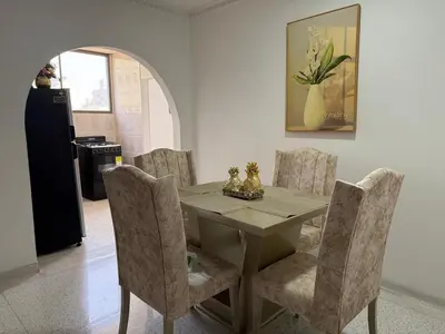 a dining room with a table and chairs at Apartamento central en Barranquilla in Barranquilla