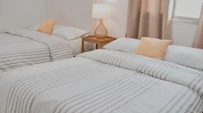 a group of three beds in a room at Apartamento Benitez 301 by Zakher in Cartagena de Indias
