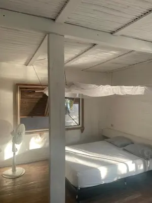 a bunk bed in a room with a window at Cabaña la bota in Rincón