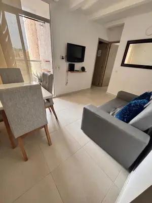 a living room with a couch and a table and a television at Cómodo y Comfortable Apto in Cartagena de Indias