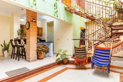 a living room with a spiral staircase in a house at Acogedora casa en Cartagena Colombia cerca a zonas turísticas in Cartagena de Indias