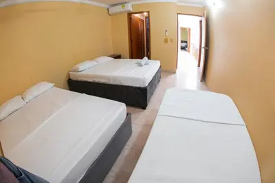 a room with two beds and a hallway at Acogedora casa en Cartagena Colombia cerca a zonas turísticas in Cartagena de Indias