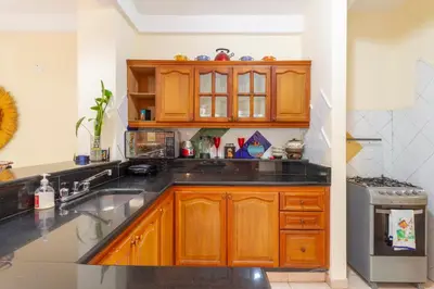 a kitchen with wooden cabinets and a sink at Acogedora casa en Cartagena Colombia cerca a zonas turísticas in Cartagena de Indias