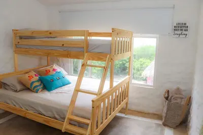 a bedroom with two bunk beds and a window at Serenity by the Sea in Juan de Acosta