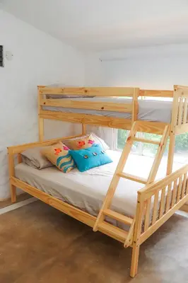 a wooden bunk bed with pillows on it in a room at Serenity by the Sea in Juan de Acosta