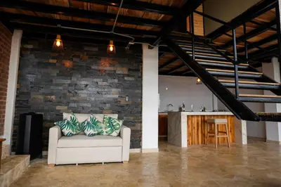a couch in a room with a brick wall at Arumake in Turbaco