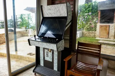 a kitchen with a stove and a chair next to a window at Arumake in Turbaco