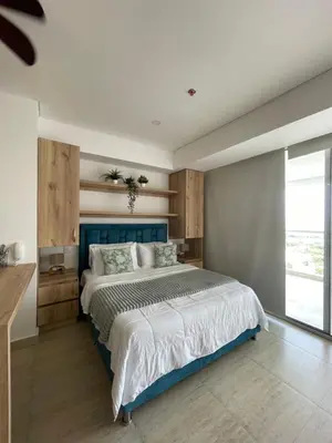 a bedroom with a large bed with a blue headboard at Crespo Horizon Suite in Cartagena de Indias
