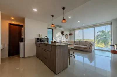 a kitchen and living room with a table and a couch at Edificio Morros Vitri, 2 Bedrooms- Comfy Apartment in Cartagena de Indias
