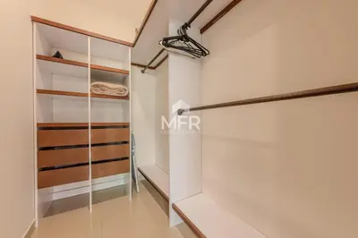 a walk in closet with white walls and wooden shelves at Edificio Morros Vitri, 2 Bedrooms- Comfy Apartment in Cartagena de Indias
