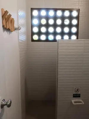 a bathroom with a shower with a window at Playa del Toro in El Bobo