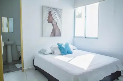 a bedroom with a bed with a picture of a woman at Cabañas El Laguito Coveñas in Coveñas