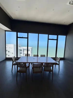 a table and chairs in a room with a large window at Murano Centro1 26floor,rooftop,infinity pool & views byIMZ in Cartagena de Indias