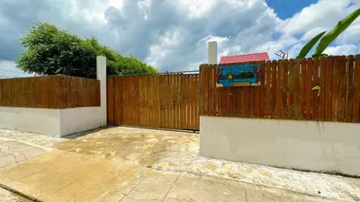 a wooden fence next to a sidewalk next to a sidewalk at La casa en el Aire in San Antero