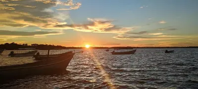 a group of boats in the water at sunset at La casa en el Aire in San Antero