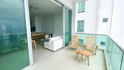 a balcony with two chairs and a couch at Magico Apartamento Frente al Mar 4 Habitaciones BM43 in Coveñitas