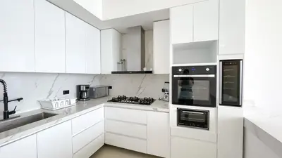 a white kitchen with white cabinets and appliances at Magico Apartamento Frente al Mar 4 Habitaciones BM43 in Coveñitas